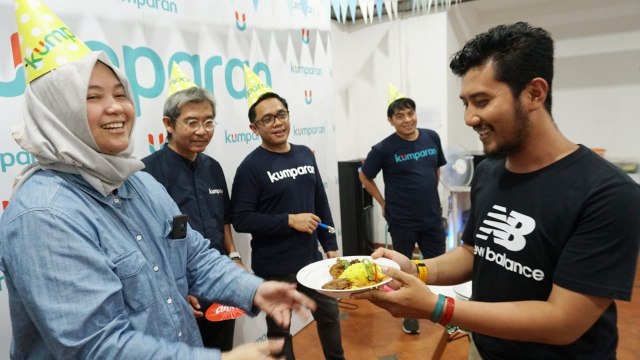 Direktur Operasional, Ine Yordenaya (kiri), secara simbolis memberikan potongan tumpeng kepada perwakilan karyawan kumparan. (Foto: Jamal Ramadhan/kumparan)