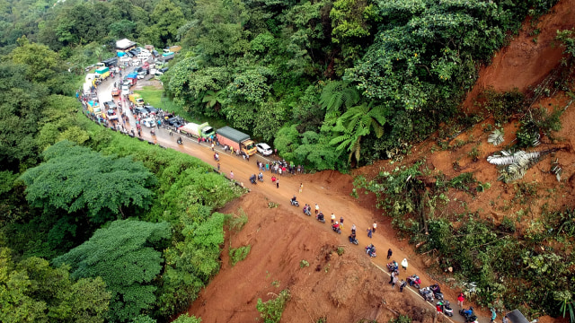 Foto udara kendaraan melintas bergantian pascapembersihan material longsor, di Jalan Lintas Padang - Jambi, di Panorama II, Sitinjau Lauik, Padang, Sumatera Barat, Rabu (12/12 (Foto: ANTARA FOTO/Iggoy el Fitra)