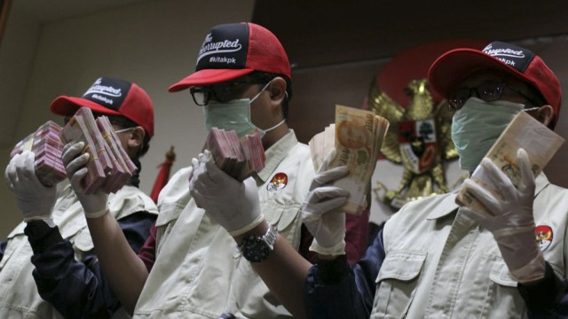 Tim KPK memperlihatkan uang yang diduga hasil korupsi, Minggu (31/12). Foto: Helmi Afandi Abdullah/kumparan