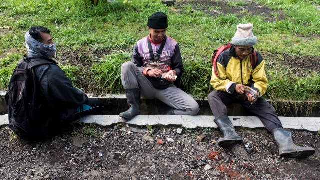 Sejumlah penambang menghitung uang seusai mengantarkan pendaki atau wisatawan. (Foto: Antara/M Agung Rajasa)