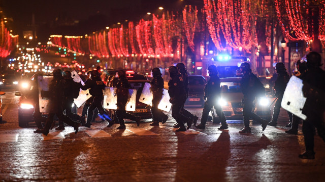 Sejumlah anggota kepolisian Perancis, saat menyebrang jalan di Champs-Elysees, Paris, Prancis, pada Sabtu (5/1/2019). (Foto: AFP/Eric FEFERBERG )