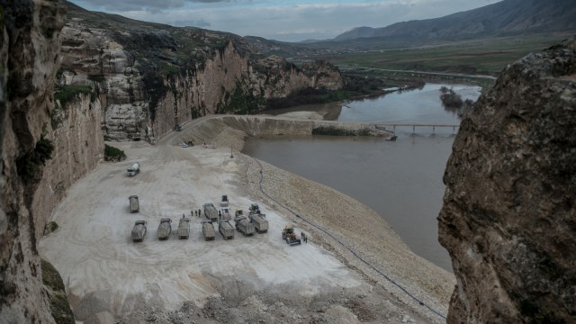 Sejumlah truk konstruksi yang berada di tepi sungai Tigris, dekat dengan Kota Hasankeyf, Turki. (Foto: AFP/BULENT KILIC)
