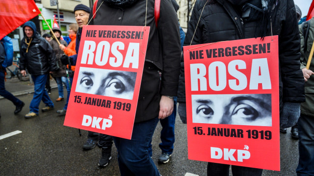 Para demonstran di membawa poster Rosa Luxemburg pada peringatan 100 tahun kematiannya di Berlin, Jerman, Minggu (13/1/2019). (Foto: AFP/JOHN MACDOUGALL )
