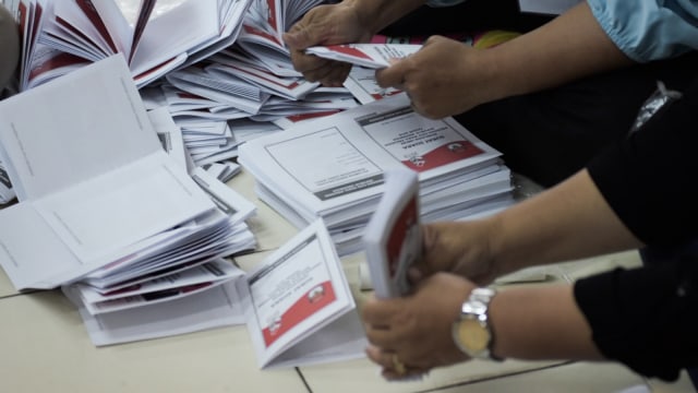 Sejumlah petugas melipat surat suara presiden dan wakil presiden Pemilu 2019 di kantor Komisi Pemilihan Umum (KPU) Jakarta Barat, Selasa (19/2). Foto: Iqbal Firdaus/kumparan