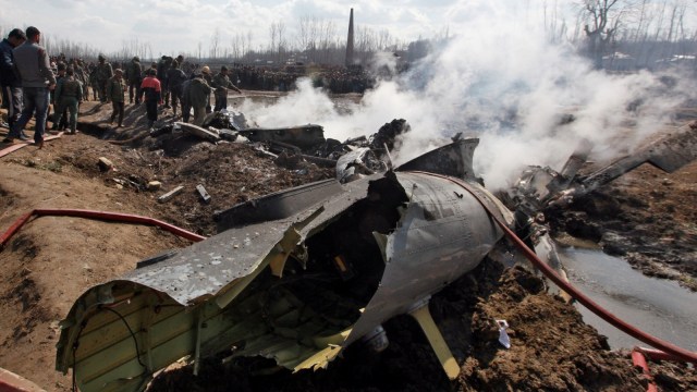 Sejumlah warga bangkai jet tempur India yang jatuh di distrik Budgam, Kashmir, Rabu, (27/2). Foto: REUTERS / Danish Ismail