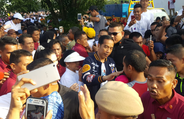 Jokowi dan Ibu Iriana menyapa warga yang ikut jalan santai di Kendari, Sabtu (2/3). Foto: Lukman Budianto/kendarinesiaid