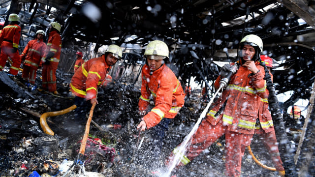 Petugas pemadam kebakaran mendinginkan sisa kebakaran di Tempat Penampungan Sementara Pasar Blok A, Kebayoran Baru, Jakarta Selatan, Rabu (6/3). Foto: ANTARA FOTO/Sigid Kurniawan