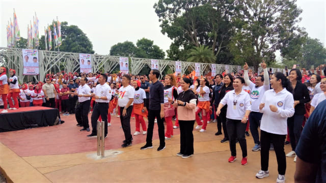 Presiden Jokowi didampingi Ibu Negara Iriana Widodo melakukan senam pagi bersama relawan di Jakabaring Sport, Palembang. Foto: Fahrian Saleh/kumparan