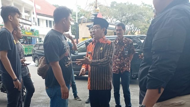 Wali Kota Malang, Sutiaji (berkopiah), saat menemui para warga yang menggalang uang untuk mengaspal jalan rusak di Kota Malang. (foto: Humas Pemkot Malang for Tugu Malang).