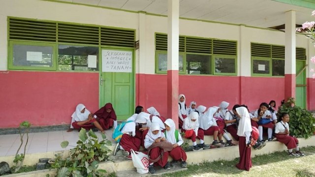 Suasana siswa siswi SDN 19 Banawa, Kabupaten Donggala belajar diluar ruangan kelas. Hal ini akibat sekolah mereka di segel oleh warga yang mengatasnamakan sebagai ahli waris tanah di sekolah tersebut. Foto: PaluPoso/Situr Wijaya