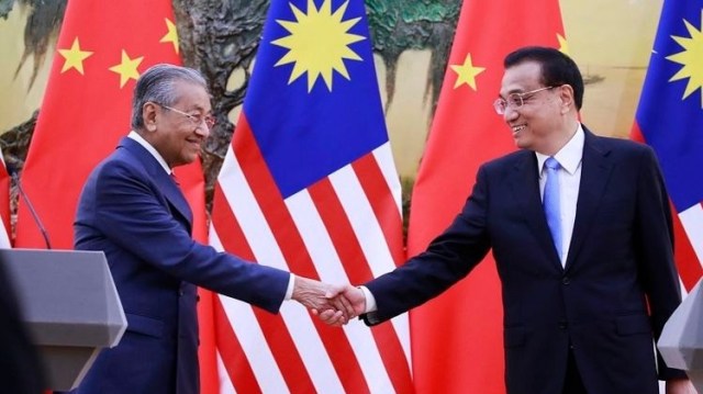 PM Malaysia Mahathir Mohamad menjabat tangan PM China Le Keqiang usai menggelar jumpa pers di Beijing, Senin (20/8/2018).