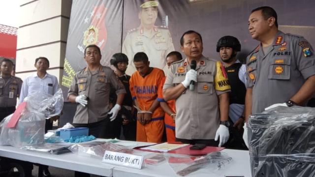 Anggota kepolisian Polda Jawa Timur menunjukkan tersangka dan barang bukti pembunuhan penari asal Kediri, Budi Hartanto di Markas Polda Jawa Timur. Foto: Yuana Fatwalloh/kumparan