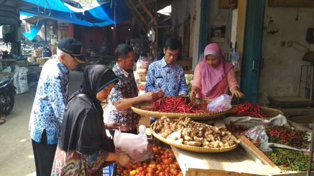 Petugas pemantau harga pasar Disperindag Kuningan melakukan pengecakan harga sembako di sejumlah pasar tradisional di Kabupaten Kuningan, Jawa Barat, Senin (22/4). (Andry)