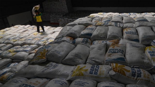 Pekerja melakukan bongkar muat beras di Gudang Bulog. Foto: ANTARA FOTO/Raisan Al Farisi