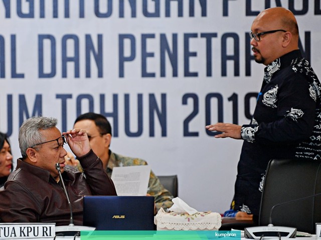 Ketua KPU Arief Budiman berbincang dengan Komisioner KPU Ilham Saputra disela memimpin Rapat Pleno Rekapitulasi Hasil Penghitungan dan Perolehan Suara. Foto: Antara/Sigid Kurniawan