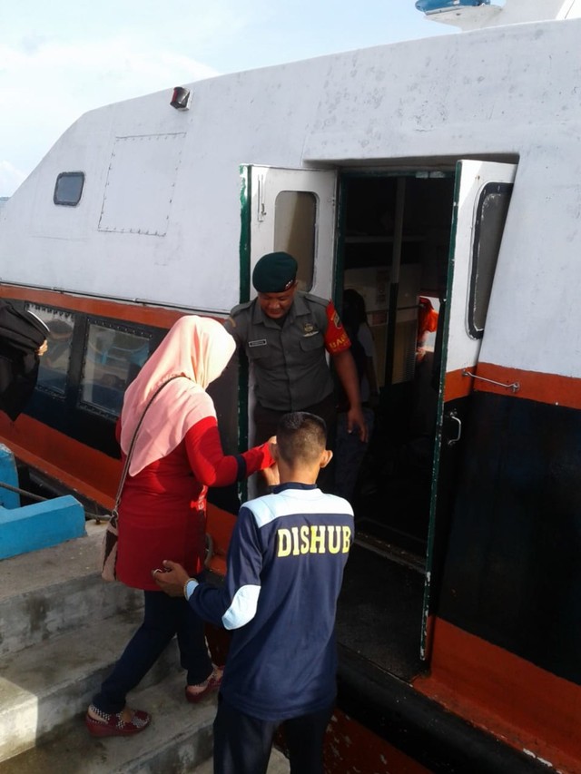Babinsa Desa Jagoh saat membantu penumpang kapal