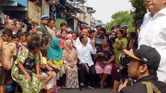 Capres nomor urut 01, Joko Widodo (tengah) menyapa warga saat akan menyampaikan pidato kemenangannya di Kampung Deret, Jakarta Pusat. Foto: Kevin Kurnianto/kumparan