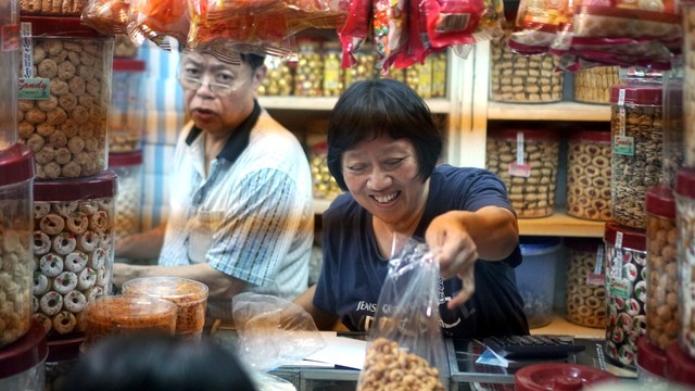 Penjual melayani pembeli kue kering di Pasar Master Jatinegara, Jakarta Timur, Minggu, (26/5). Foto: Iqbal Firdaus/kumparan