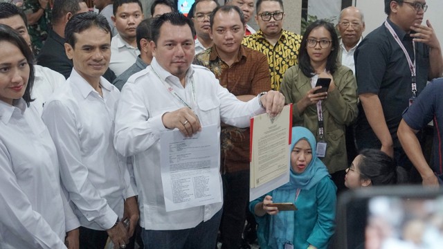 Direktur Advokasi dan Hukum Tim Kampanye Nasional (TKN) Jokowi-Amin Ade Irfan Pulungan (tengah) saat menunjukan surat gugatan di MK. Foto: Helmi Afandi Abdullah/kumparan