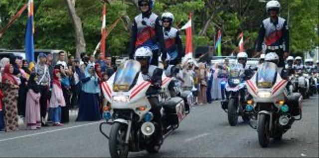 Seorang Polwan dari satuan Patroli Jalan Raya (PJR) Dirlantas Polda Aceh melakukan atraksi Safety Riding. Foto: ANTARA FOTO/Ampelsa