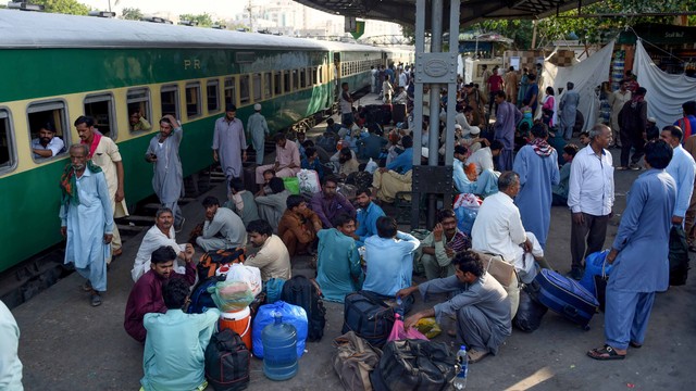 Sejumah warga Pakistan menunggu kereta untuk pulang ke rumah untuk bersama keluarga mereka menjelang festival Muslim Idul Fitri, di Karachi pada 2 Juni 2019. Foto: AFP/RIZWAN TABASSUM