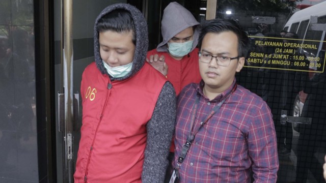 Pablo (kiri) dan Galih Ginanjar (tengah) saat dibawa anggota kepolisian di Polda Metro Jaya, Jakarta, Jumat, (12/7). Foto: Ronny