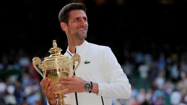 Djokovic dan trofi Wimbledon. Foto: REUTERS/Andrew Couldridge