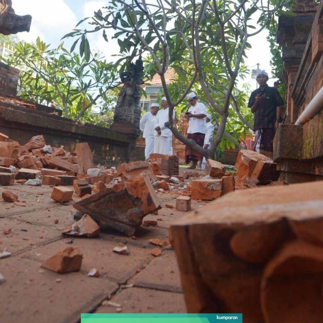 Pemuka agama Hindu memantau kerusakan pada bagian candi yang runtuh akibat gempa di Pura Lokanatha, Denpasar, Bali, Selasa (16/7). Foto: ANTARA FOTO/Nyoman Budhiana