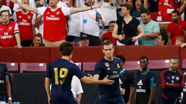 Selebrasi Bale bersama Alvaro Odriozola setelah mencetak gol di laga ICC 2019 melawan Arsenal. Foto: Geoff Burke-USA TODAY Sports
