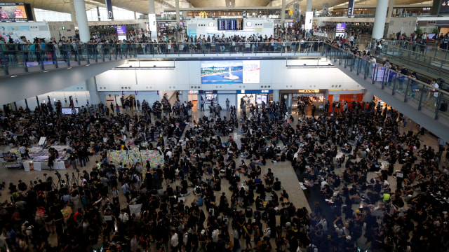 Penumpang pesawat yang terlantar karena Bandara Hong Kong ditutup karena Demo. Foto: REUTERS/Edgar Su