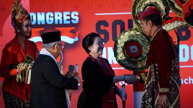 Presiden Joko Widodo (kanan) bersalaman dengan Megawati Soekarnoputri (tengah), usai membuka Kongres V PDIP, di Bali, Kamis (8/8). Foto: Jamal Ramadhan/kumparan