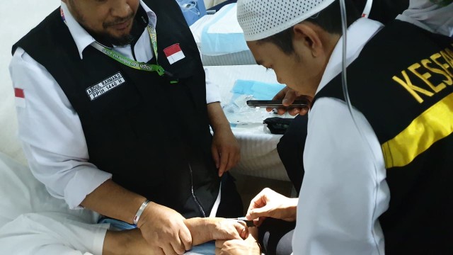 Petugas haji Indonesia membantu jemaah sakit di Mina Foto: kumparan/Denny Armandhanu