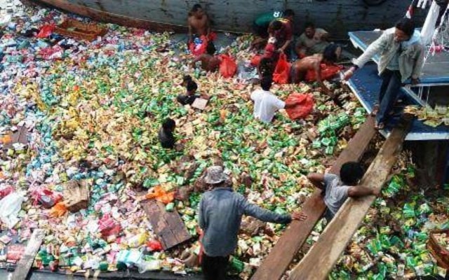 Warga memungut ribuan bungkus mi instan yang mengapung usai KM Usaha Bersama karam di Pelabuhan Dwikora, Karimun. (Foto: istimewa)