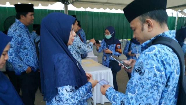 PNS Pemprov DKI absen menggunakan barcode saat Upacara Kemerdekaan di Pulau Reklamasi, Jakarta, Sabtu (17/8). Foto: Paulina Herasmaranindar/kumparan
