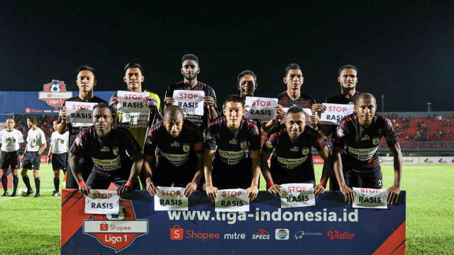 Para pemain Persipura berpose dengan kertas bertuliskan pesan anti rasis. Foto: Dok. Liga Indonesia