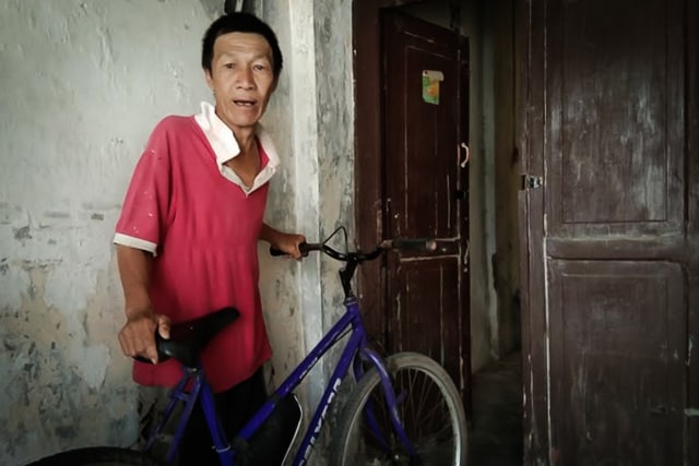 Afuk dan sepeda ontelnya yang digunakan ke Pasuruan untuk mengembalikan dompet berisi STNK dan surat-surat lainnya. (Tara Wahyu)