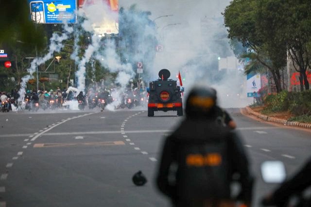 Petugas kepolisian menembaki gas air mata ke arah pendemo. Foto: Aditia Noviansyah/kumparan