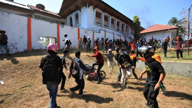 Sejumlah mahasiswa pendemo menolak UU KPK dan RUU KUHP menarik sepeda motor dan merusaknya dari gedung DPRD Provinsi Sulawesi Tenggara setelah menjebol pagar, Kendari. Foto: ANTARA FOTO/Jojon