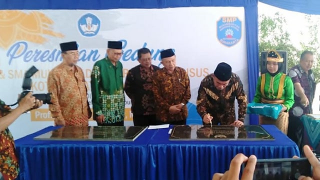 Mendikbud Muhadjir Effendy saat menandatangani prasasti peresmian gedung SMP dan SMA Muhammadiyah Program Khusus. (Fernando Fitusia)