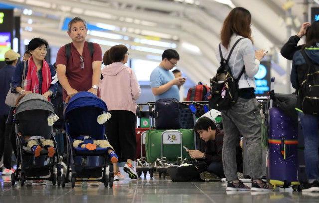 Penumpang lelah untuk menunggu penerbangan di Bandara Internasional Kansai di Prefektur Osaka pada 12 Oktober 2019.  Foto: REUTERS
