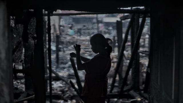 Seorang anak korban kebakaran yang masih mencari sejumlah benda berharga di dalam rumahnya yang terbakar, Kamis (17/10) Foto: ary priyanto/Urban Id