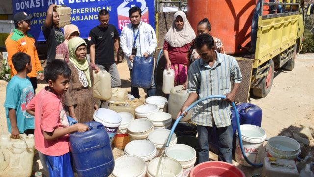 Warga antre saat tim XL Axiata menyalurkan donasi air bersih di Dusun Sidomakmur, Desa Kasihan, Kecamatan Tegalombo, Pacitan, Jawa Timur, Kamis (17/10/2019). Foto: ANTARA FOTO/Siswowidodo