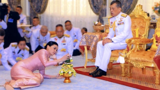 Raja Maha Vajiralongkorn dan pendampingnya, Ratu Suthida, melakukan ritual tradisional pada upacara pernikahan mereka di Bangkok.  Foto: REUTERS