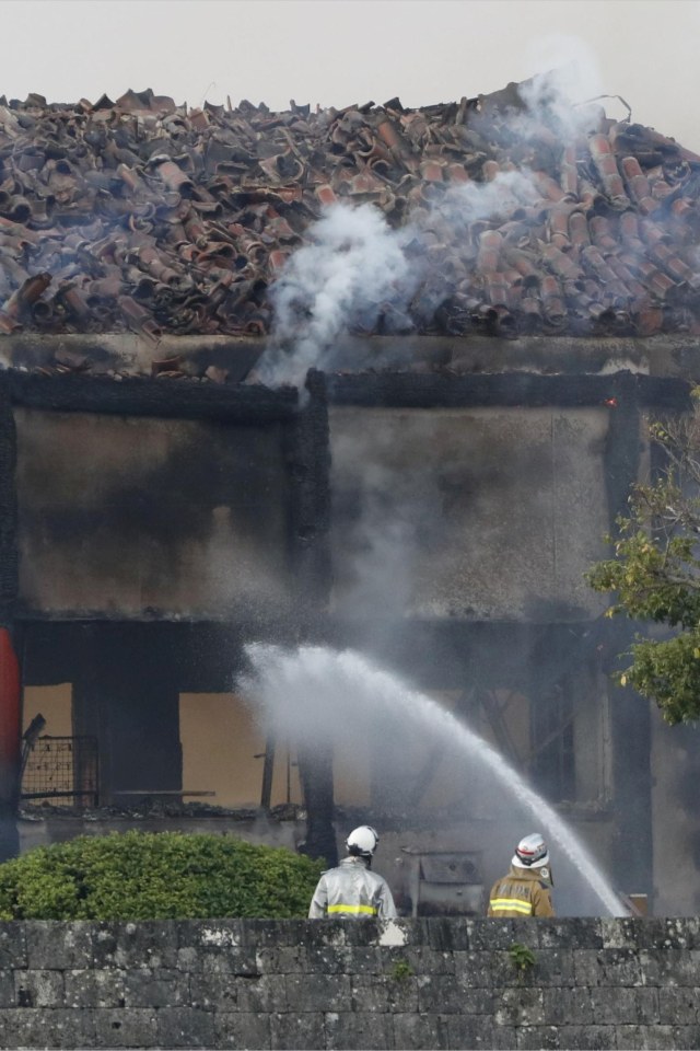 Petugas berusaha memadamkan Kastil Shuri, yang terdaftar sebagai situs Warisan Dunia, di Naha di pulau selatan Okinawa, Jepang Rabu (31/10/2019). Foto: Kyodo/via REUTERS