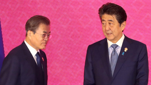 PM Jepang Shinzo Abe (kanan) bertemu dengan Presiden Korea Selatan Moon Jae in saat KTT ASEAN Plus Tiga ke-22 di Bangkok, Thailand, Senin (4/11). Foto: Reuters