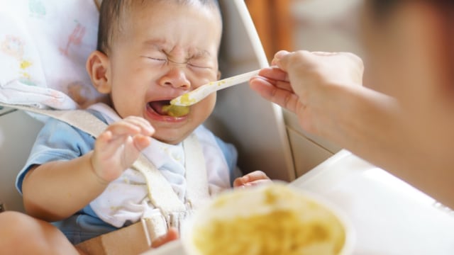 Ilustrasi bayi menjulurkan lidah saat diberi MPASI. Foto: Shutterstock