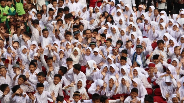 Gubernur DKI Jakarta Anies Baswedan berfoto bersama siswa SD usai memberikan program Pemberian Makanan Tambahan Anak Sekolah (PMTAS). Foto: Dok. Pemprov DKI