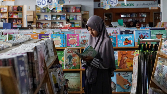 Pengunjung membaca buku paduan soal CPNS yang dijual di Pasar Kenari, Jakarta (30/11).  Foto: Jamal Ramadhan/kumparan 
