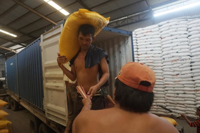 Pekerja mengangkut karung berisi beras di Gudang Perum Bulog, Jakarta. Foto: Iqbal Firdaus/kumparan