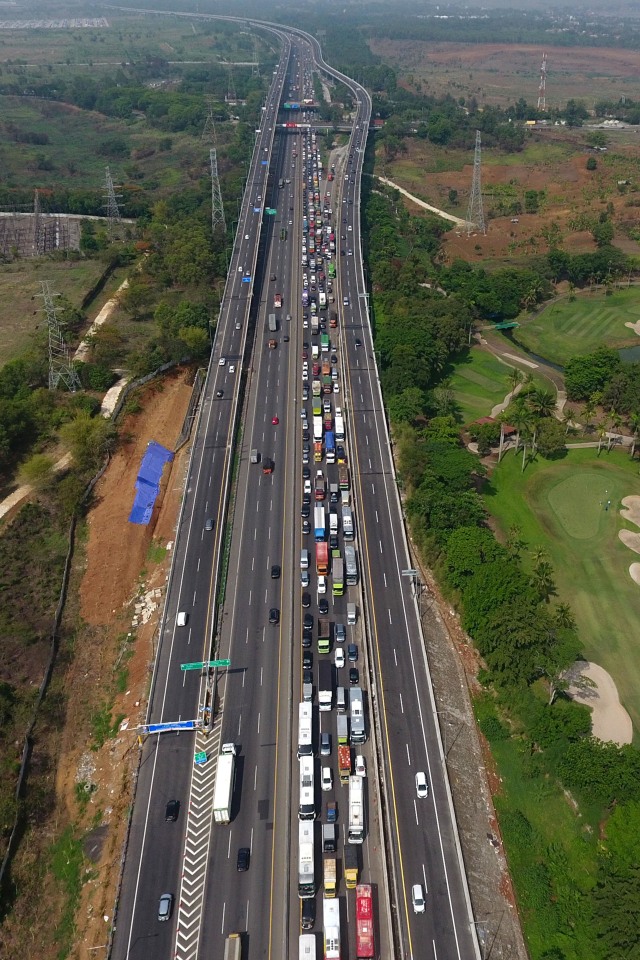 Suasana antrean kendaraan bermotor yang melintas di titik pertemuan Tol Jakarta-Cikampek elevated II dengan Tol Jakarta-Cikampek KM 48, Senin (23/12). Foto: ANTARA FOTO/Aditya Pradana Putra